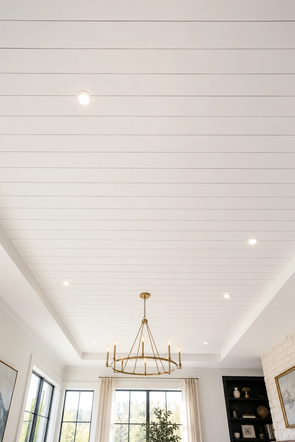 Bright white horizontal shiplap ceiling with perfectly aligned recessed LED lights, elegant brass modern chandelier, smooth painted wood planks, clean tray ceiling design, luxury contemporary living room, timeless modern farmhouse ceiling, bright open interior with natural daylight, premium white ceiling makeover, sophisticated architectural ceiling detail, classic shiplap ceiling ideas for stylish homes