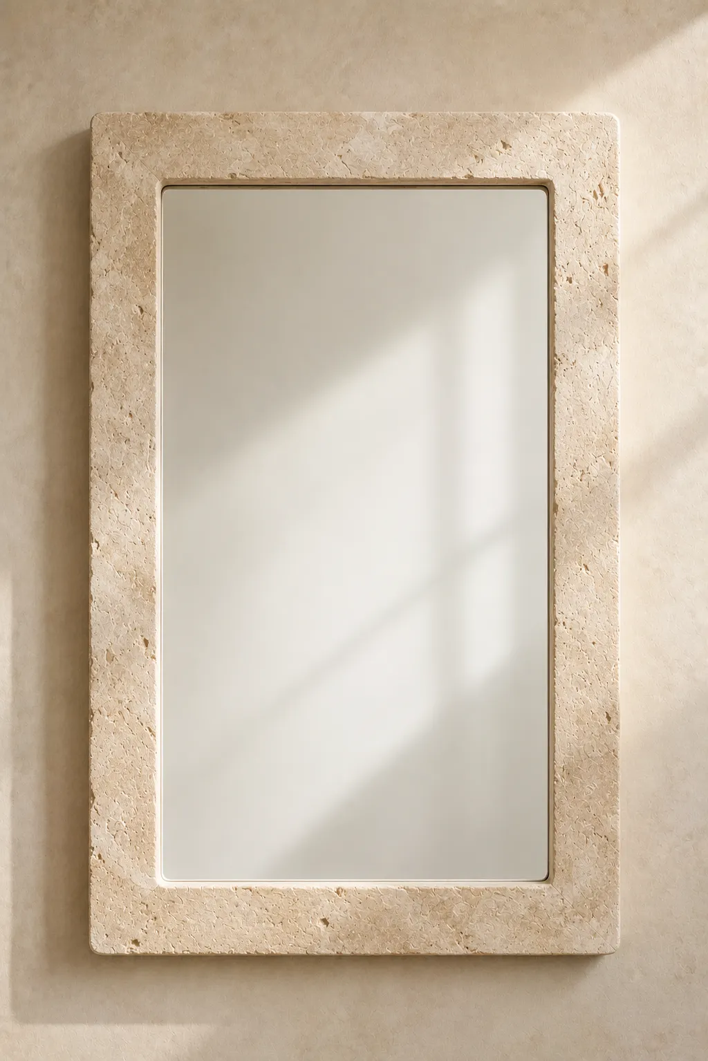 Faux stone mirror frame featuring a handcrafted rectangular wall mirror with a realistic limestone inspired frame showcasing natural mineral texture, soft ivory tones, and elegant stone detailing. Mounted on a warm plaster wall, this DIY mirror frame is perfect for modern organic interiors, Mediterranean home décor, luxury bathroom mirrors, entryway styling, and stone inspired DIY home projects.