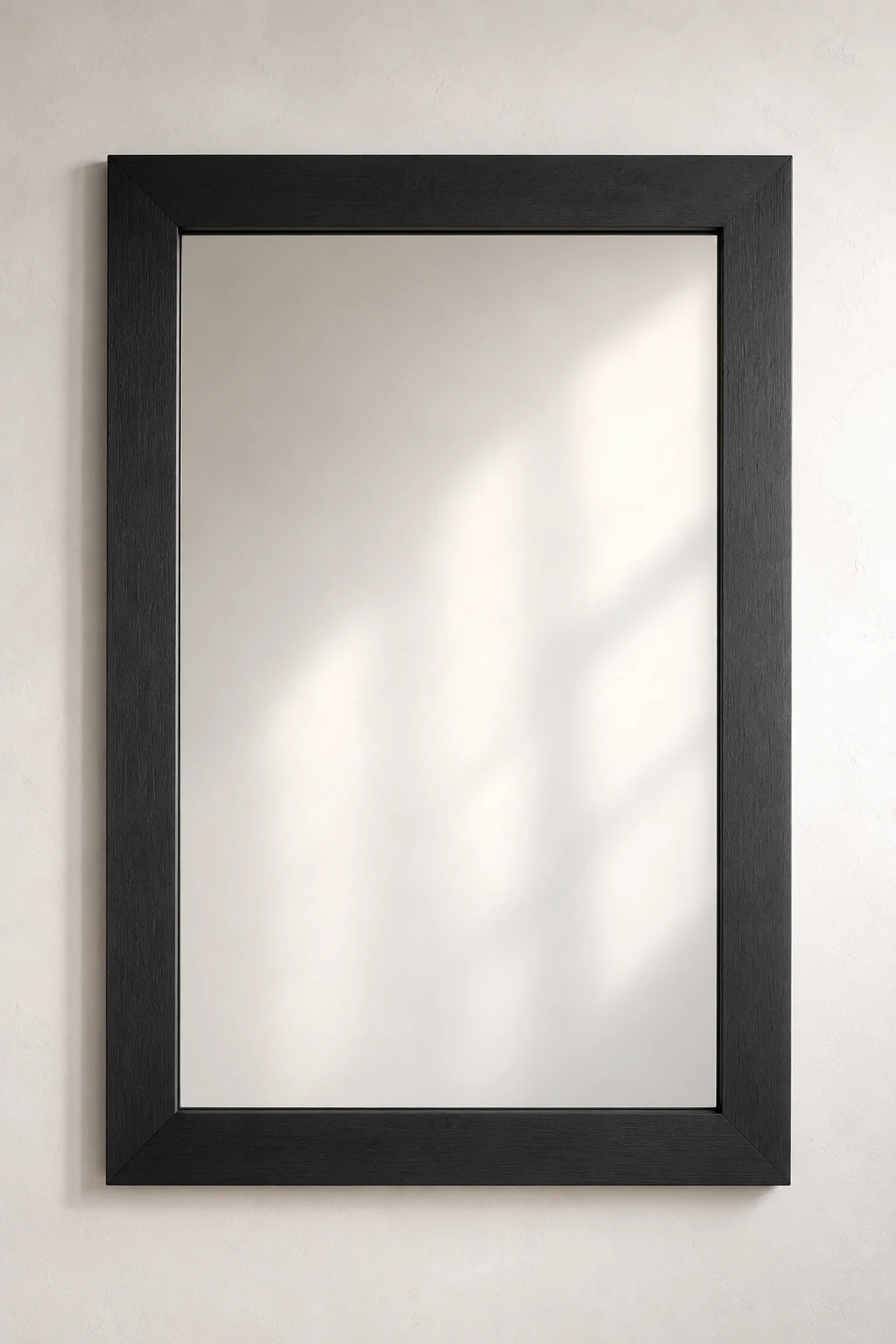 Modern matte black mirror frame featuring a large rectangular wall mirror with a sleek handcrafted wooden frame finished in deep matte black. Mounted on a clean neutral wall, this minimalist DIY mirror frame is perfect for contemporary bathrooms, modern entryways, industrial home décor, black framed mirror inspiration, luxury interior design, and affordable mirror makeover ideas.