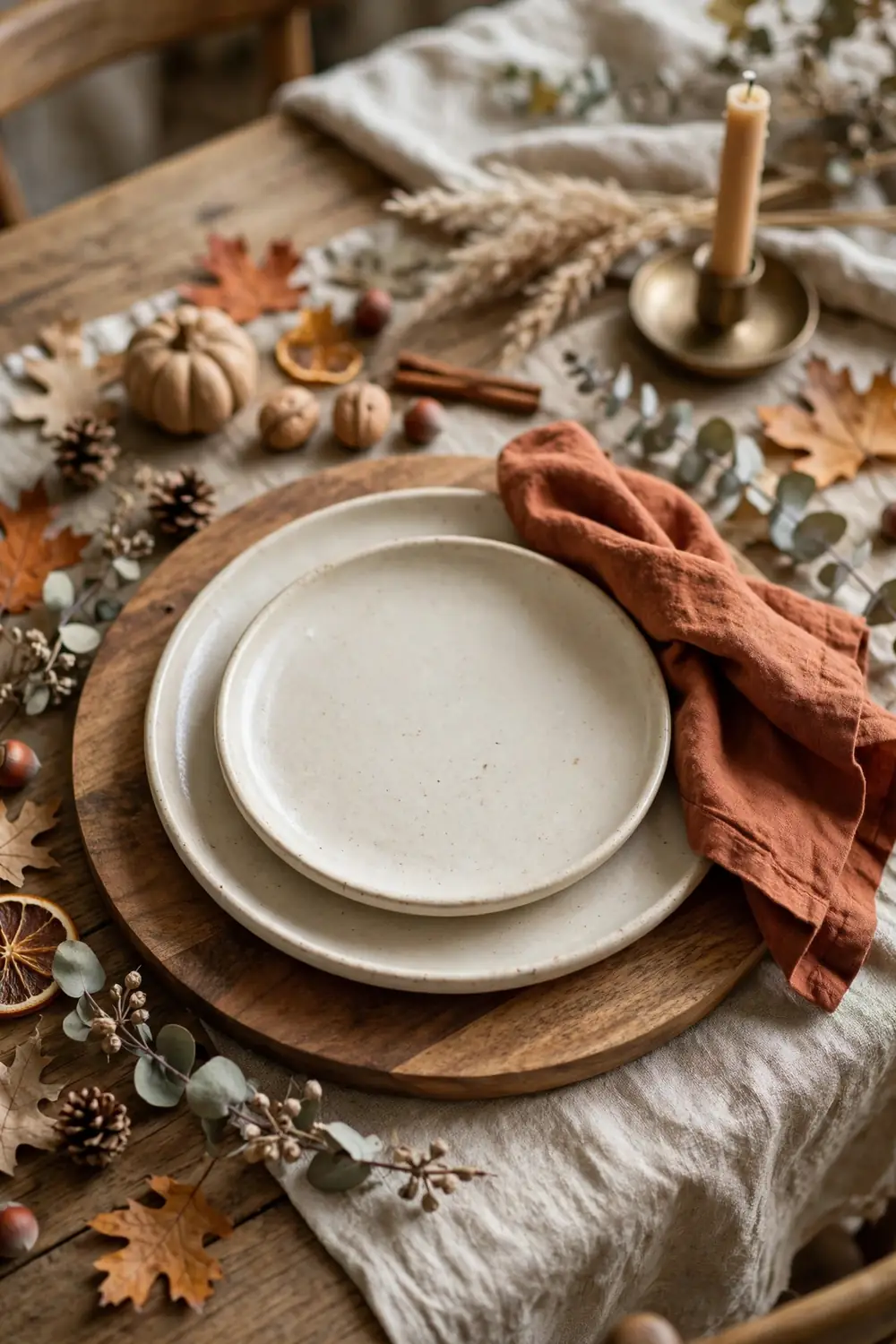 Wooden Charger Place Setting Cozy fall dining room place setting with a wooden charger, stoneware plates and rust linen napkin
