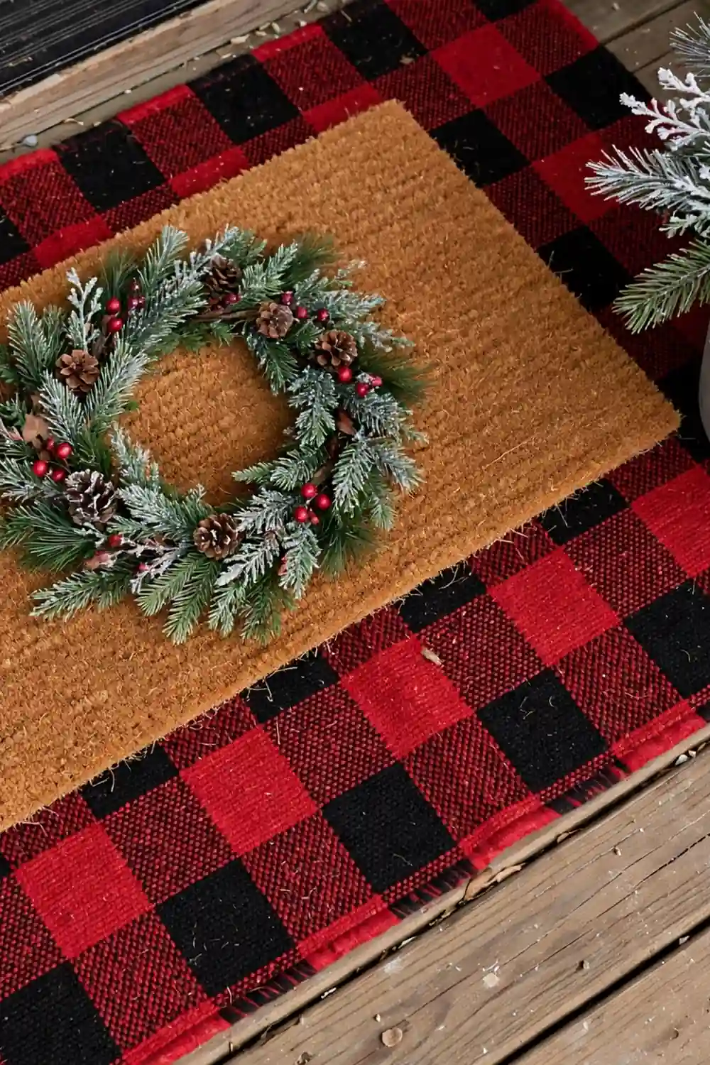 Layered doormat look with buffalo check base rug Layered doormat with buffalo check rug underneath, a simple christmas porch decor idea that welcomes guests